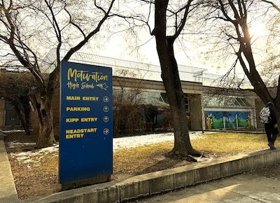 A blue sign in front of a building.