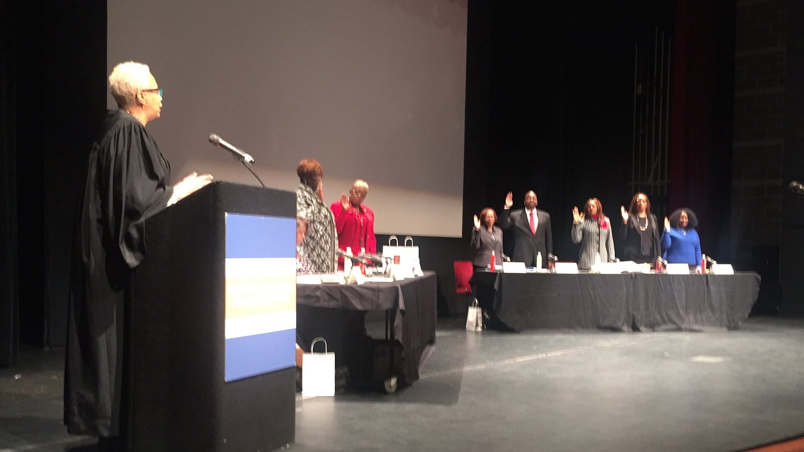 The seven members of the new Detroit school board were sworn in during their first meeting at Cass Tech high school.