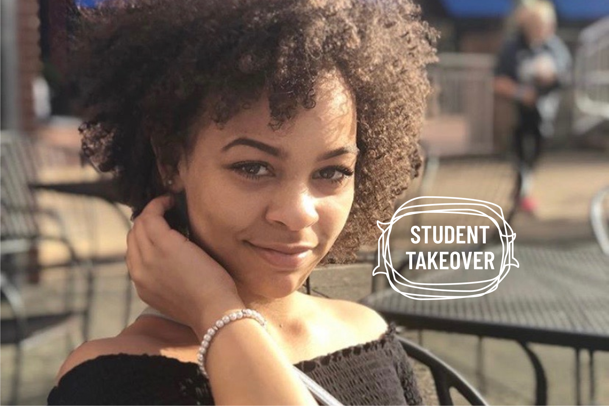 Sophia Perry with her arm resting on her neck, smiling at the camera.