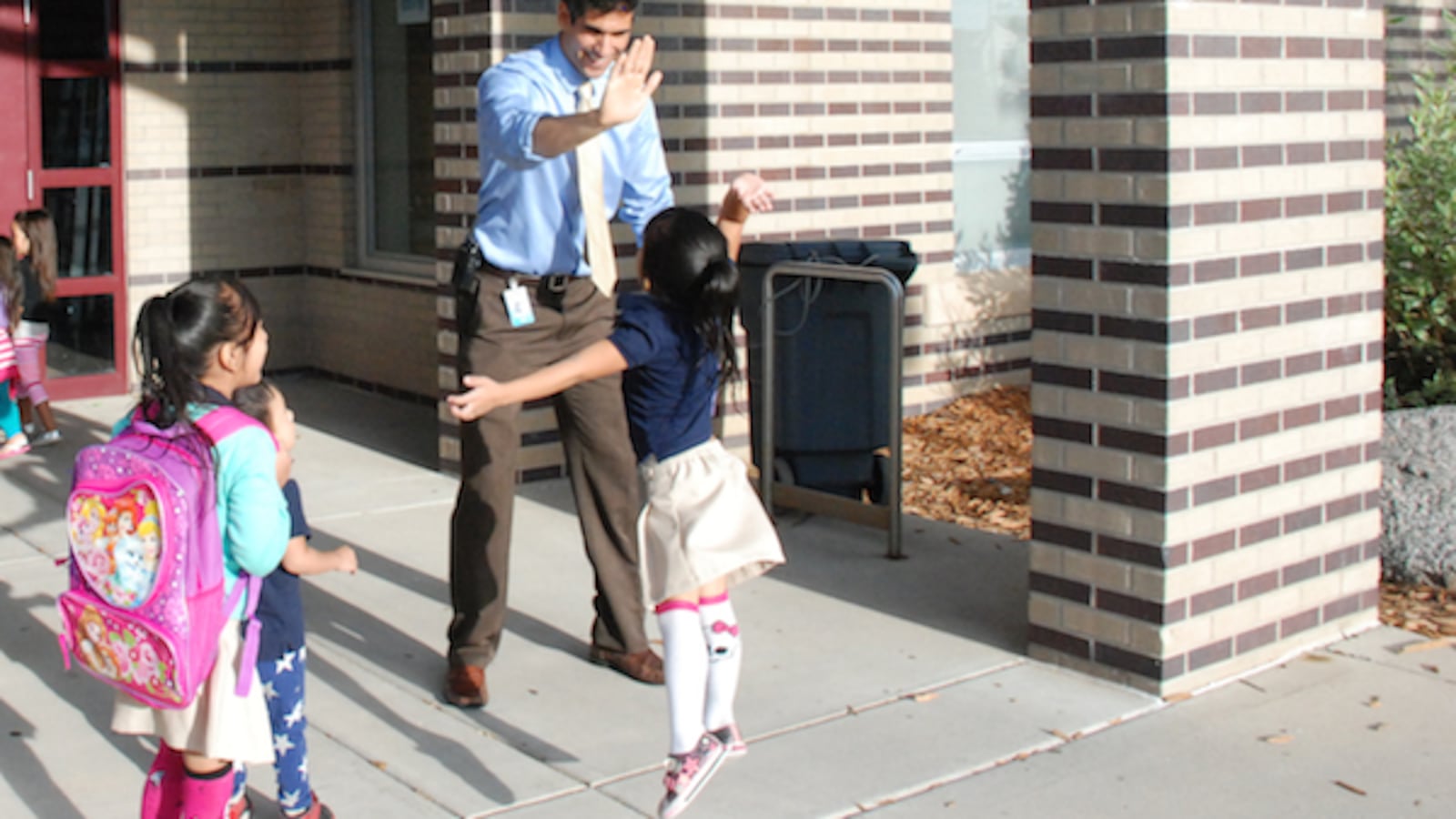 Maxwell Elementary principal Nivan Khosravi greets students as they arrive. Several weeks into the semester, he still had new students arriving.