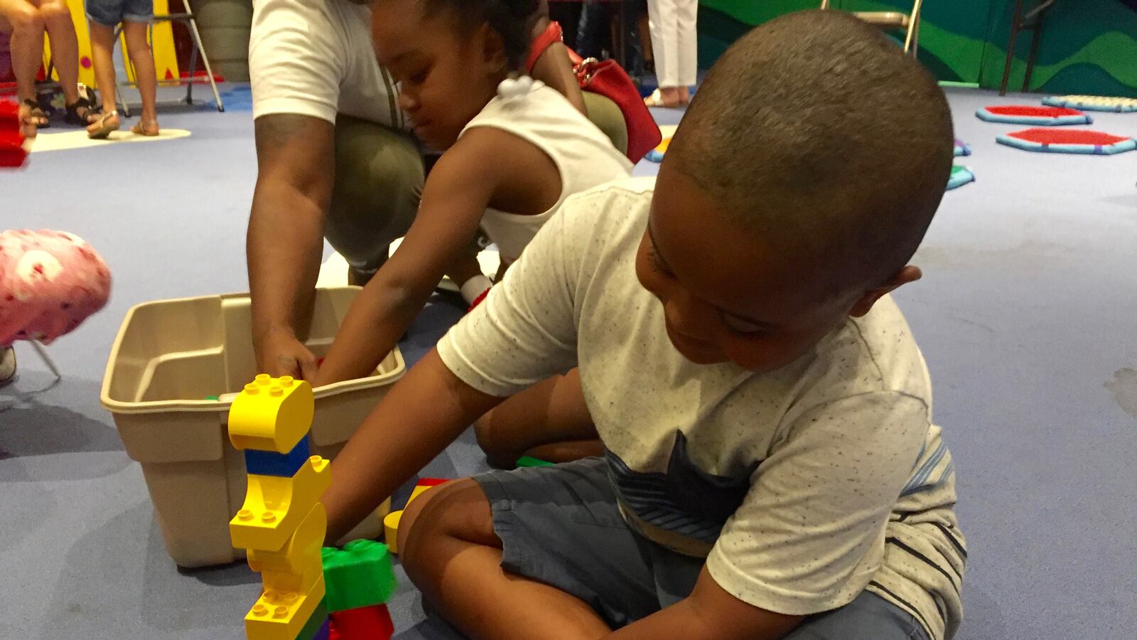 Torrence Echols, a rising first-grader in Memphis, builds a tower with giant legos at the Benjamin L. Hooks Library on National Summer Learning Day.