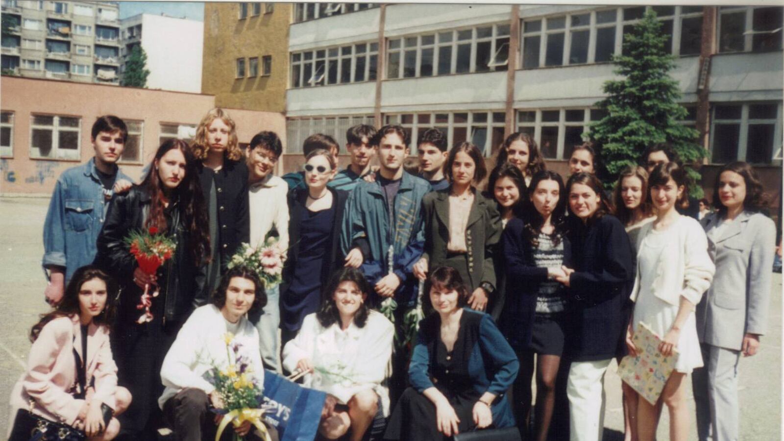 Chalkbeat Chicago reporter Mila Koumpilova (pictured second from right in a white dress) at age 18 with her class in front of her high school in Sofia, Bulgaria.