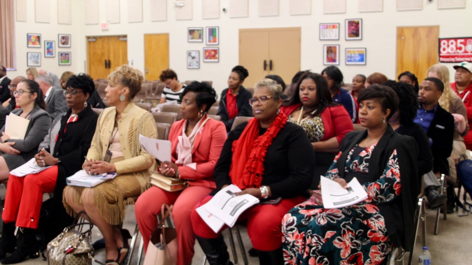 Members of the public listen during a hearing for Southwest Early College High School.