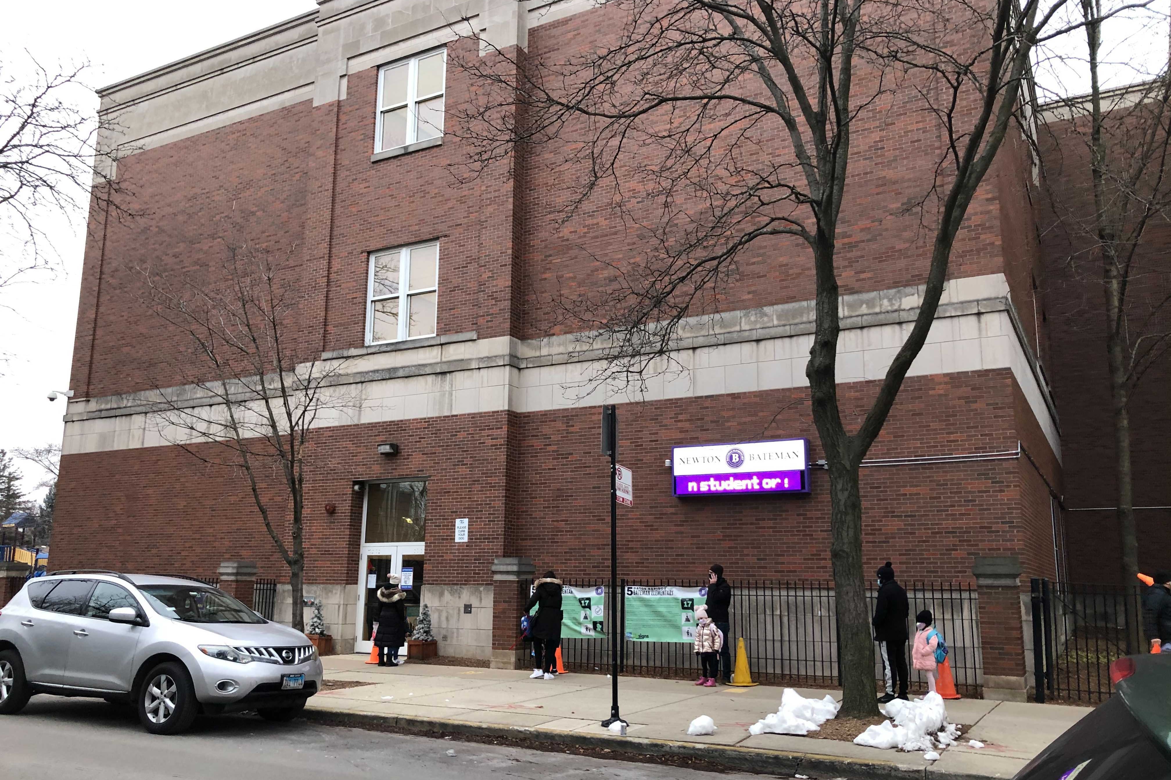 Families line up outside Bateman Elementary in Albany Park on the first day of in-person school.