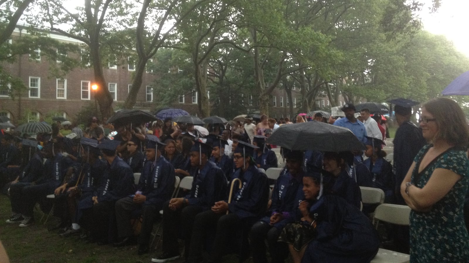 Students listened to their valedictorian in the rain, before lightning caused the ceremony to be moved inside.