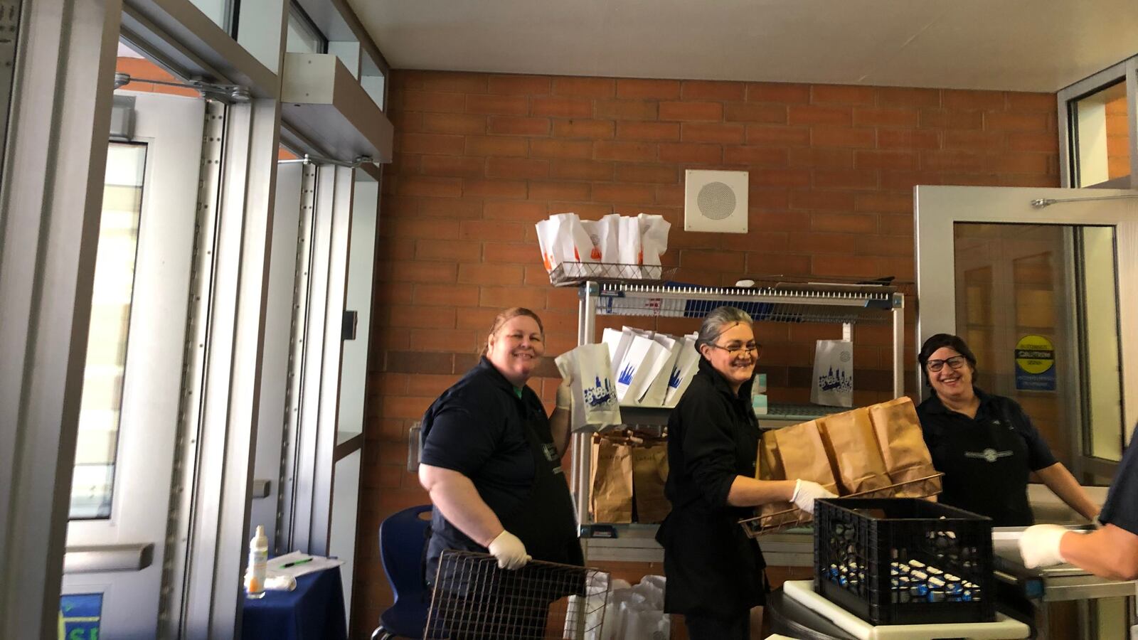 The lunchroom staff at Federico Garcia Lorca Elementary pose on the first week of food distribution in Chicago. The district had distributed 13 million meals as of June 1.