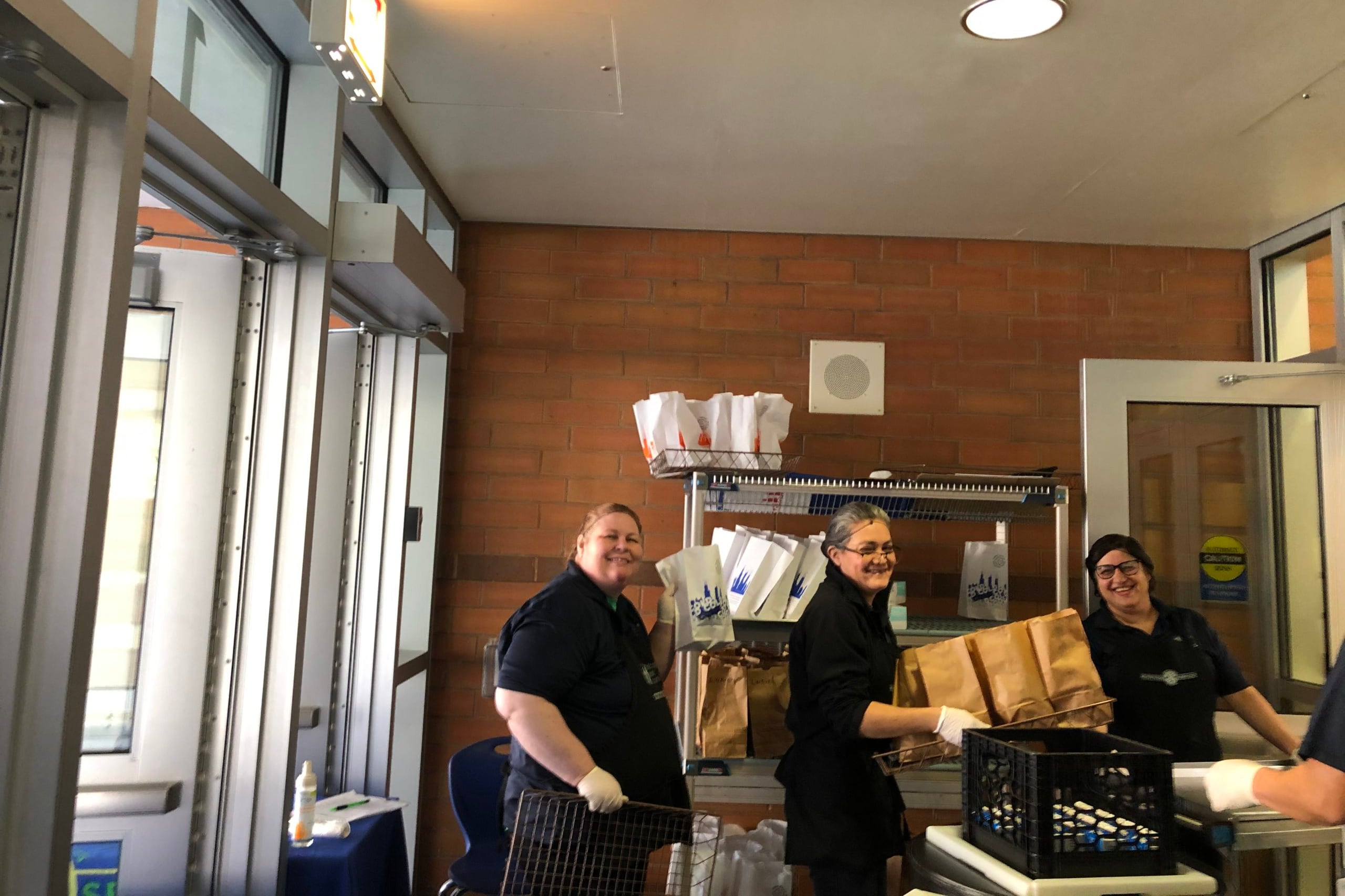 The lunchroom staff at Federico Garcia Lorca Elementary pose on the first week of food distribution in Chicago. The district had distributed 13 million meals as of June 1.