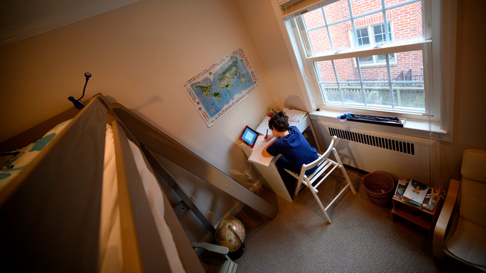 Colin, 10, whose school was closed following the Coronavirus outbreak, does school exercises at home in Washington on March 20, 2020. (Photo by ERIC BARADAT/AFP via Getty Images)