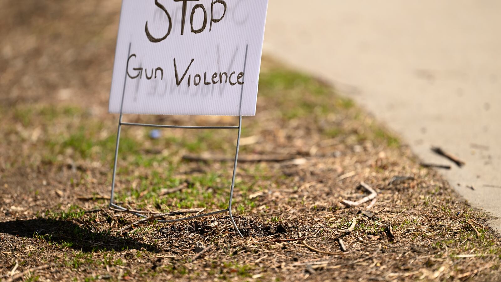 A handwritten lawn sign that says “Stop Gun Violence.”