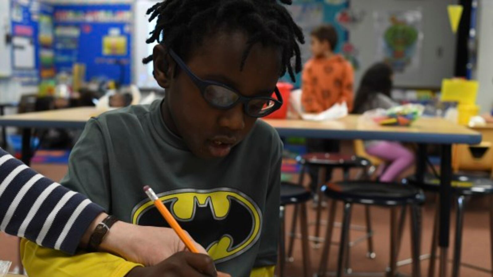 Tyree Howard, 5, gets help with his shapes during kindergarten class at Westgate Elementary School in Lakewood, Colorado.