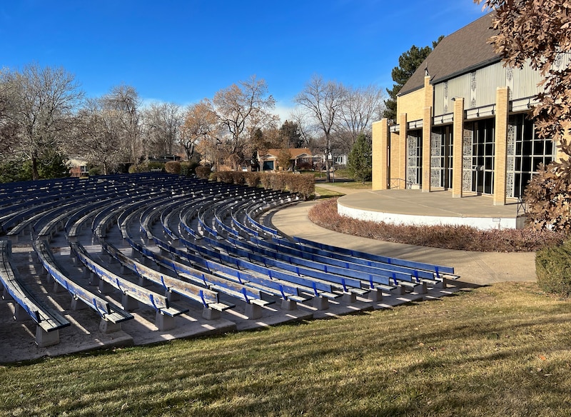 Outdoor seating next to a large stone chapel.