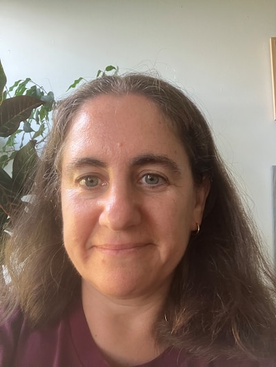 A portrait of a woman with long dark hair.