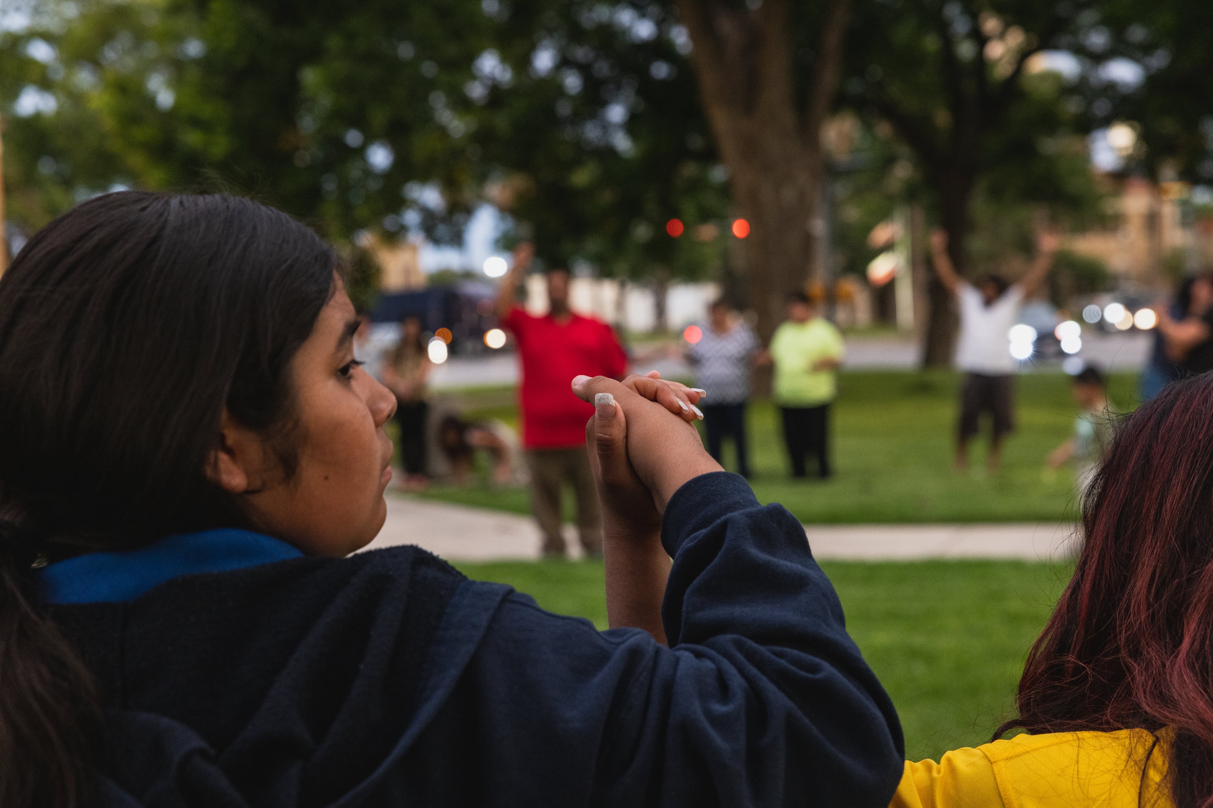 Young mourners hold hands during a vigil in the aftermath of a school shooting in Uvalde, Texas.
