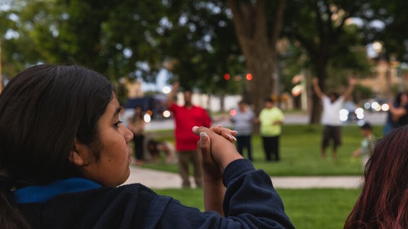 Young mourners hold hands during a vigil in the aftermath of a school shooting in Uvalde, Texas.