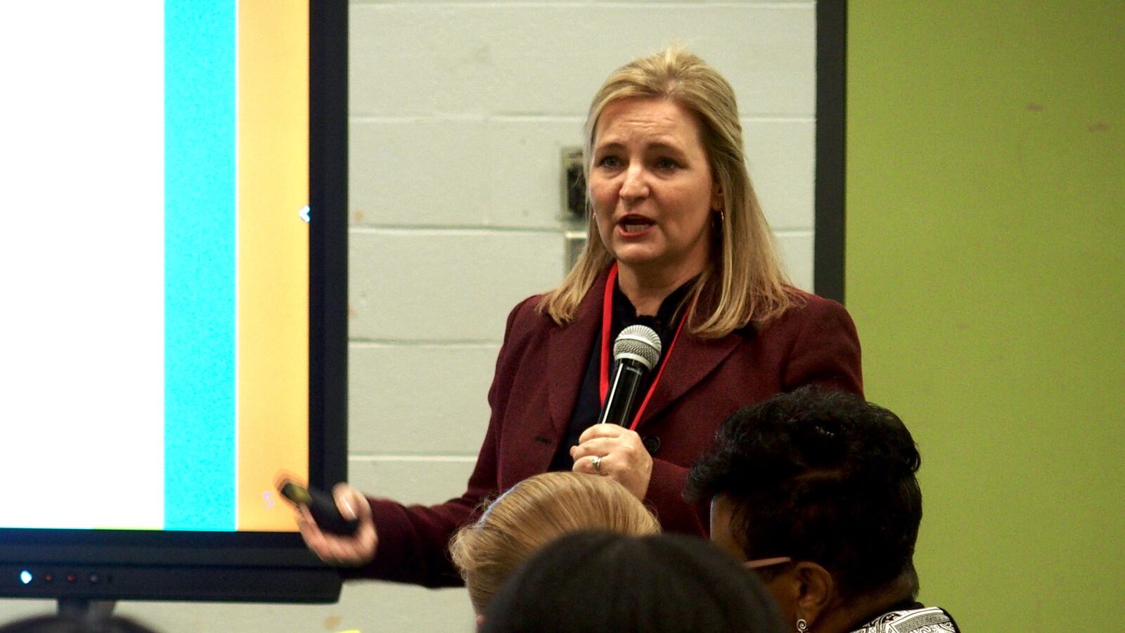 Eve Carney holds a remote for her presentation to an audience at Trezevant High School’s cafeteria in January 2020.