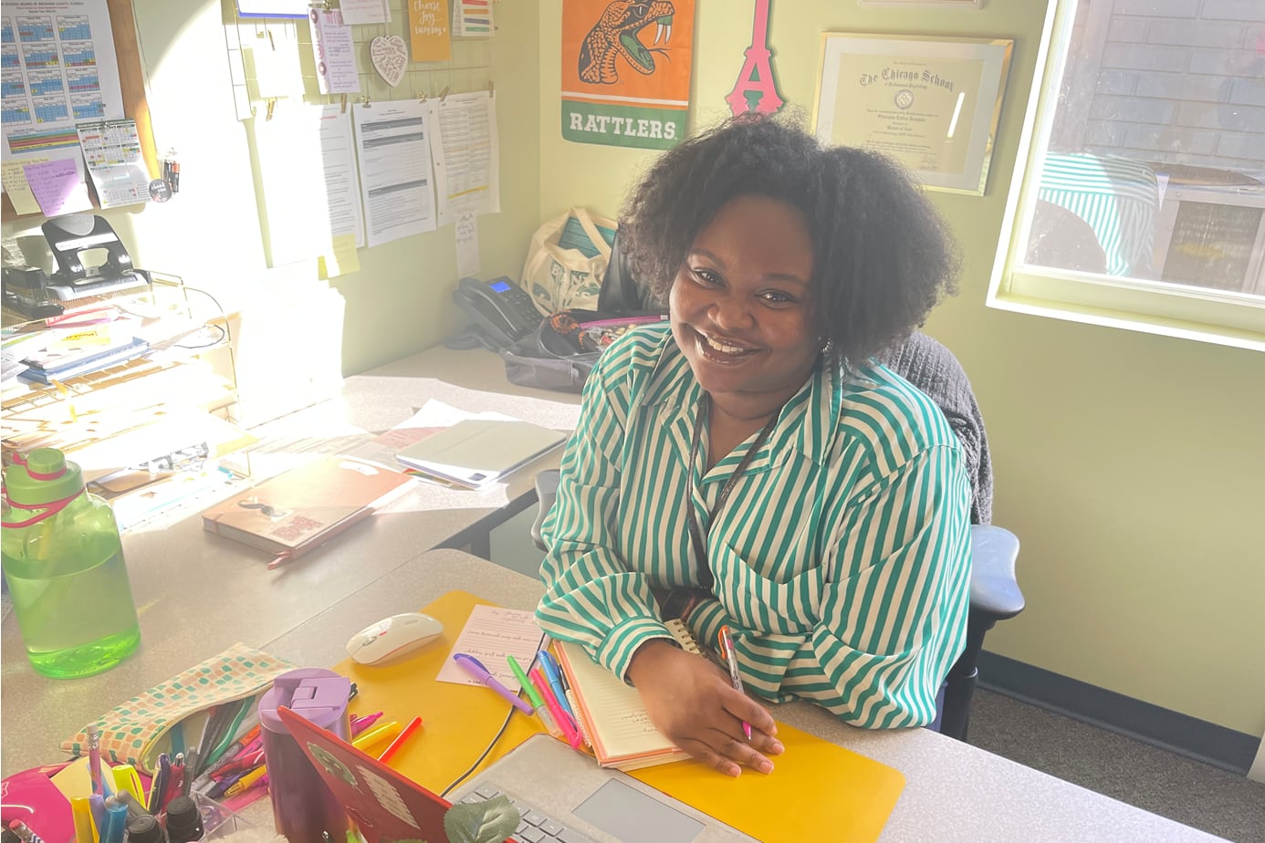 Sharayne Douglas sits at a desk in her office.