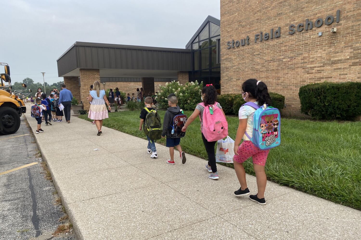 children walk into a school
