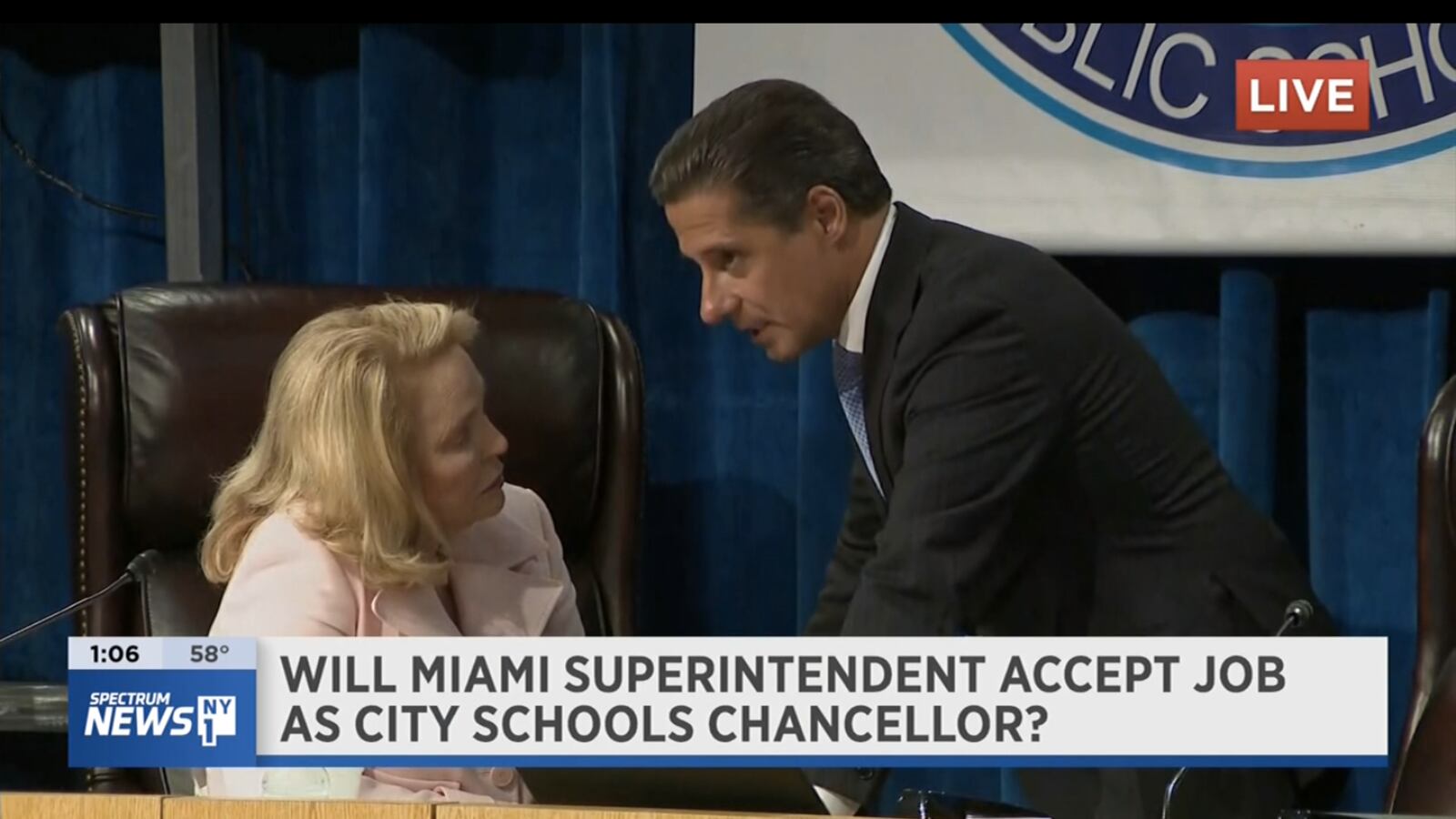 Cavalho talks to Miami’s school board chair during a break in the meeting Thursday.