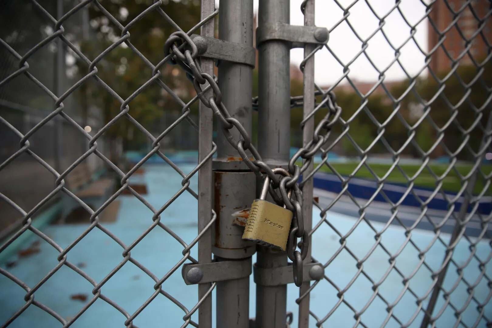 A chain linked fence is locked. 
