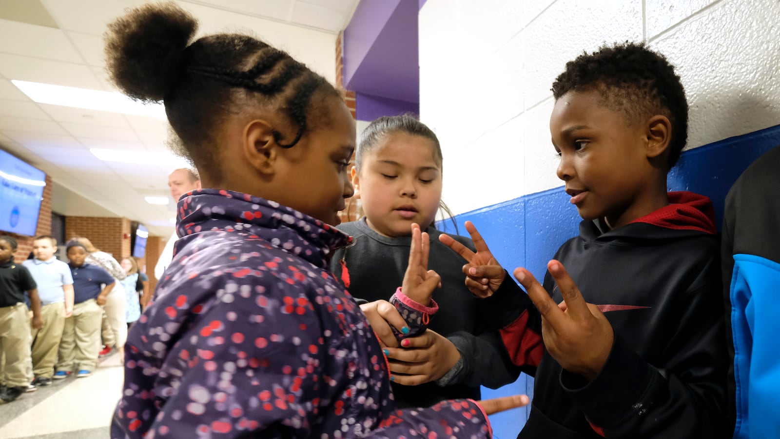Students interact with one another before class at Thomas Gregg Neighborhood School, an elementary school in Indianapolis, Indiana.