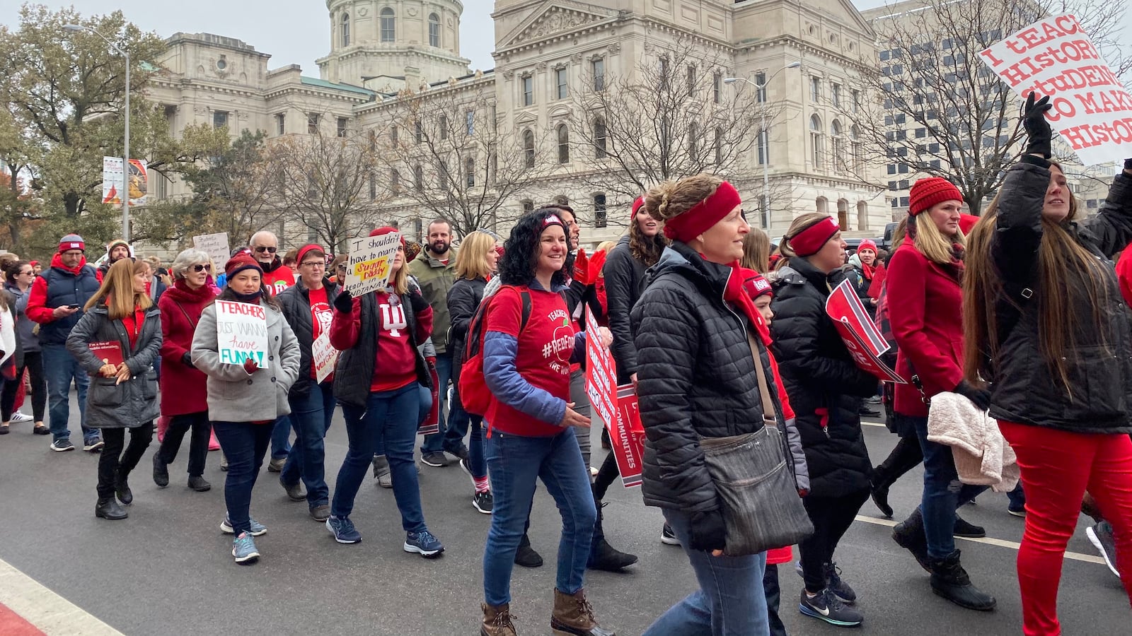 Red for Ed supporters march up Capitol Avenue around the Indiana Statehouse on Tuesday, Nov. 19, 2019.