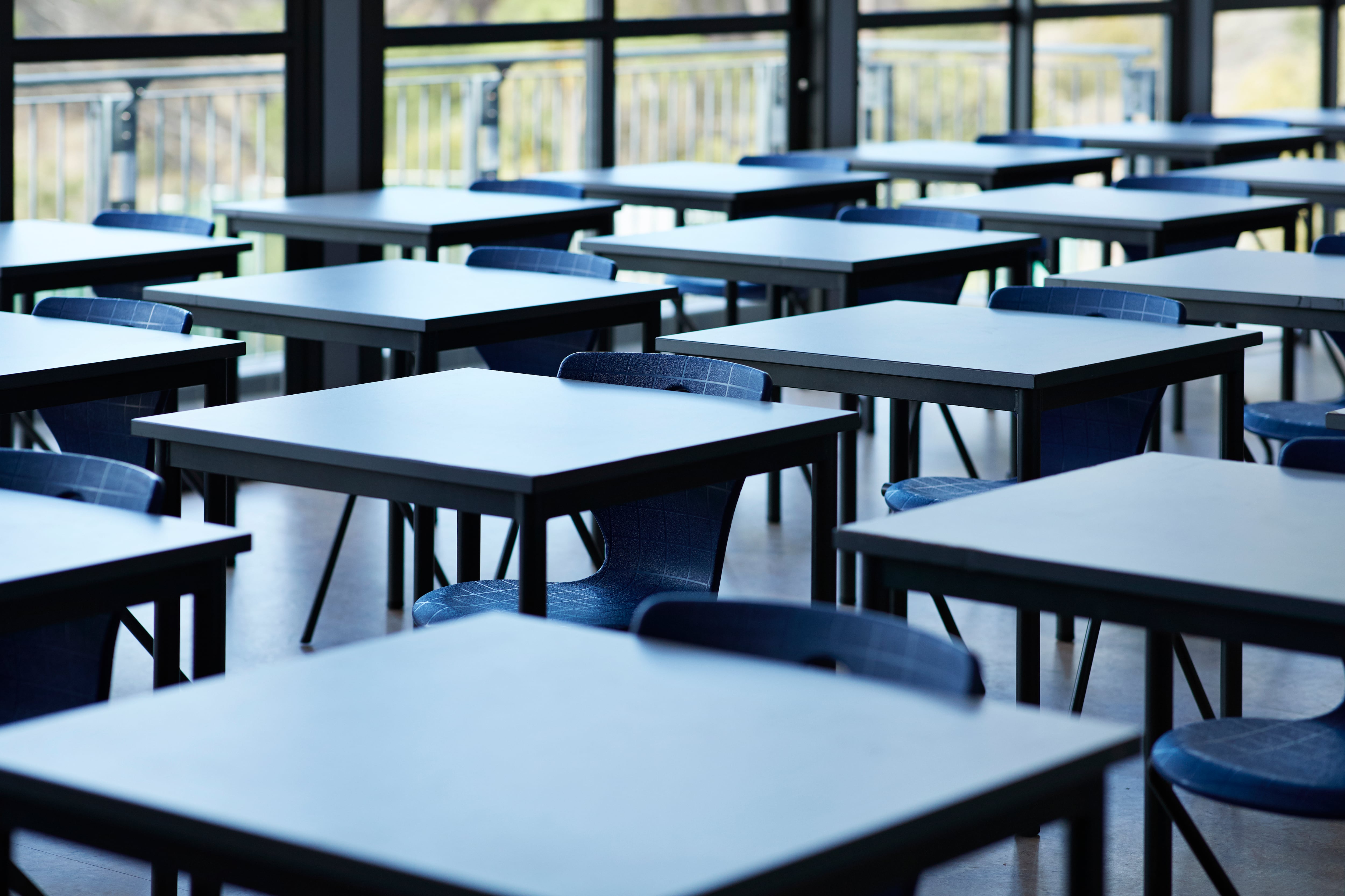 Rows of empty desks near a window