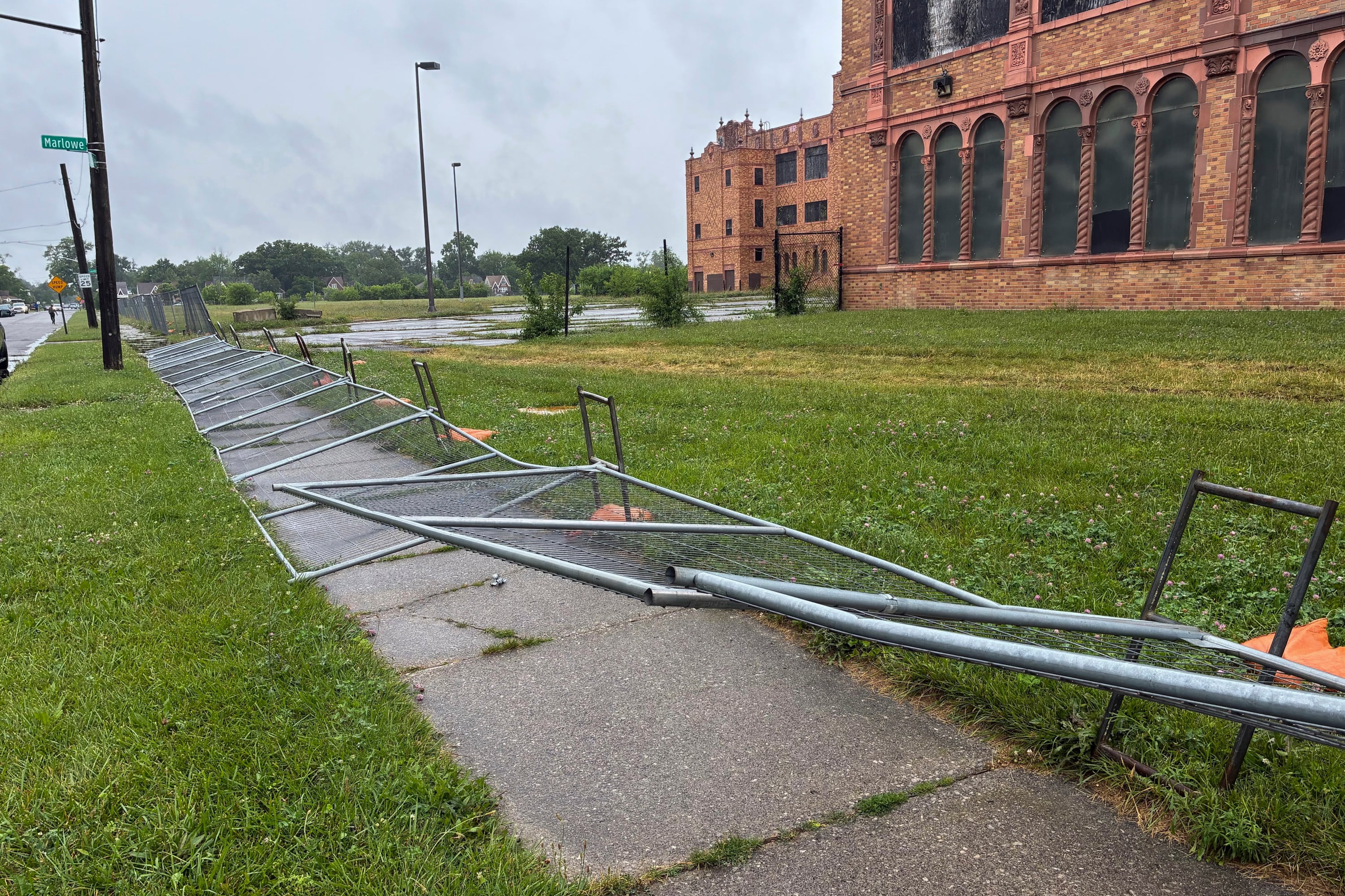 A photograph of fences fell on the sidewalk outside Cooley High School.