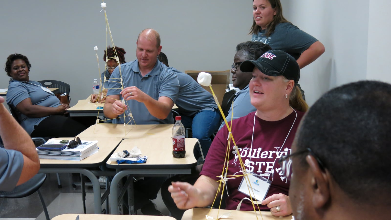 Collierville High School biology teacher Brooke Parker (center) constructs a tower using spaghetti strings during an ASM Materials Camp at Southwest Tennessee Community College in Memphis.