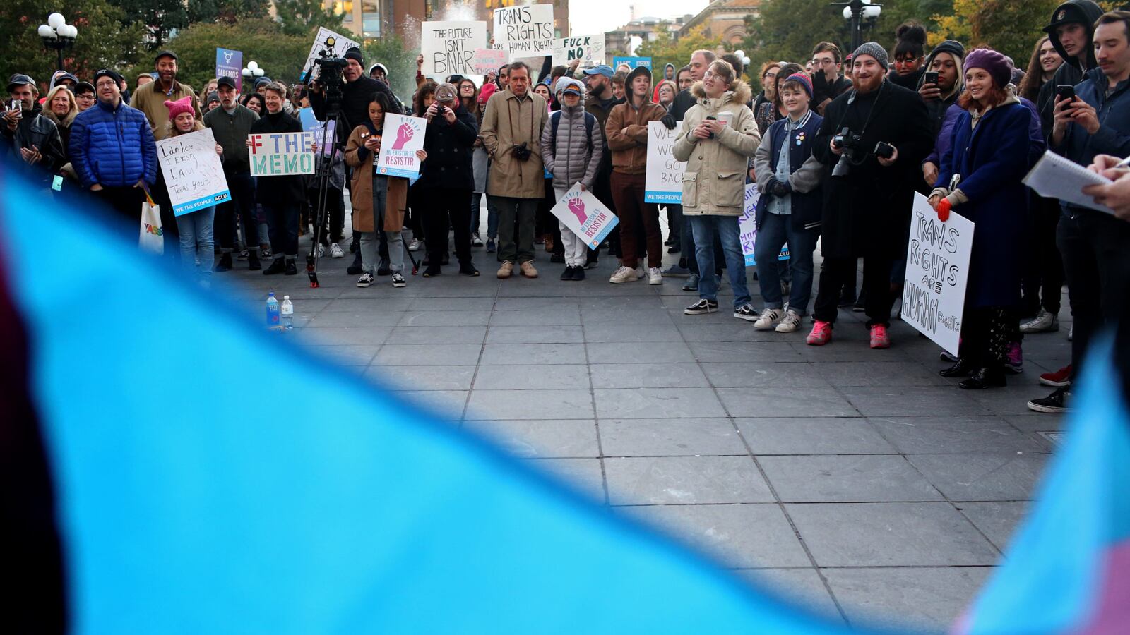 A flag for transgender and gender noncomforming people is held up at a rally for LGBTQ rights at Washington Square Park.