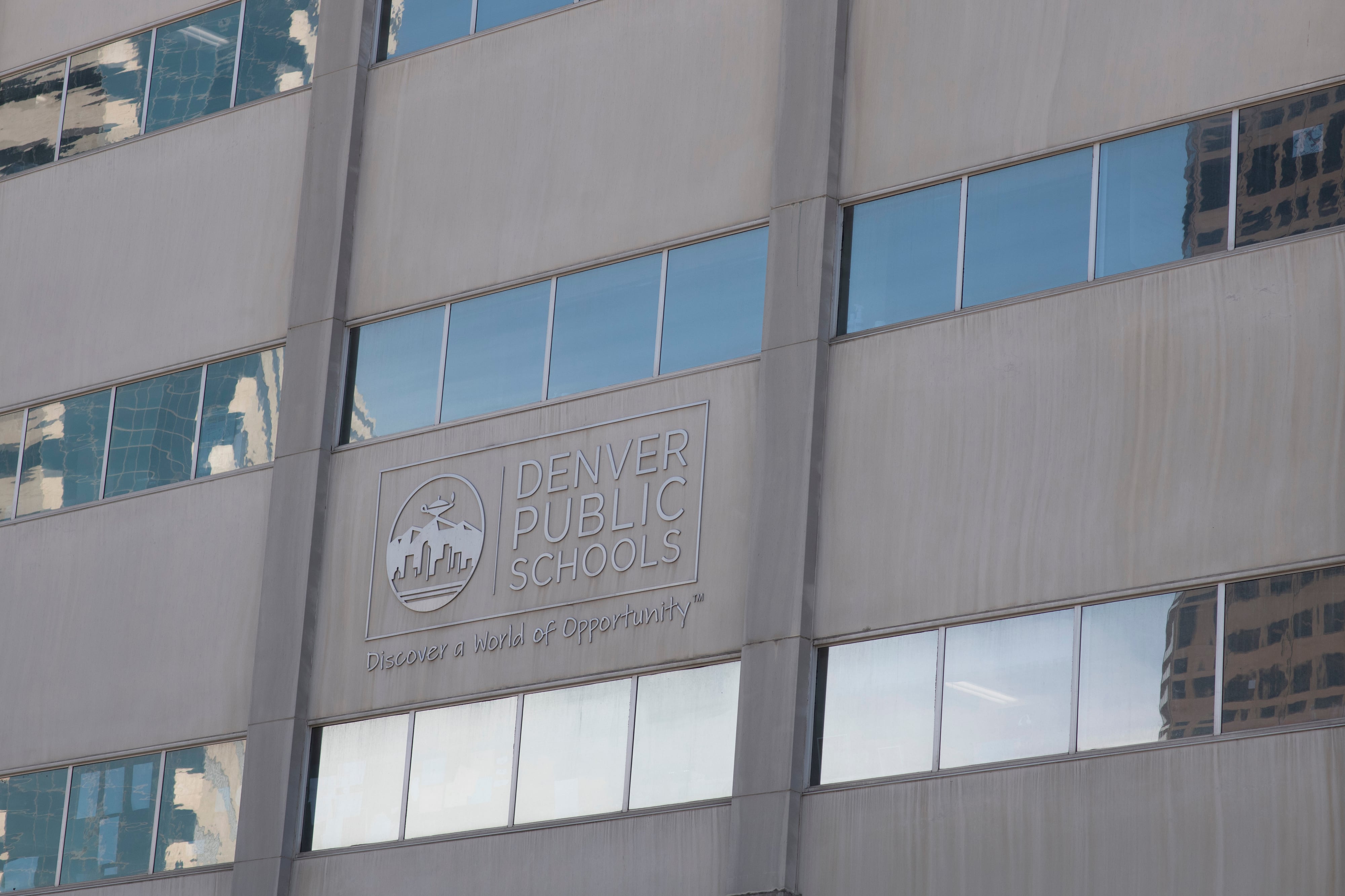 The front of Denver Public Schools offices, a gray building with windows