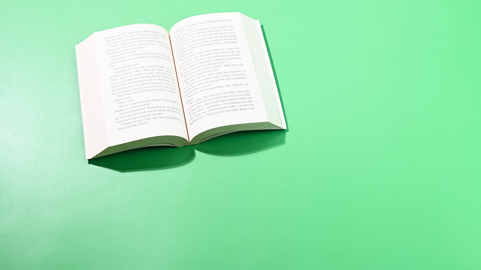 An open book against a light green background
