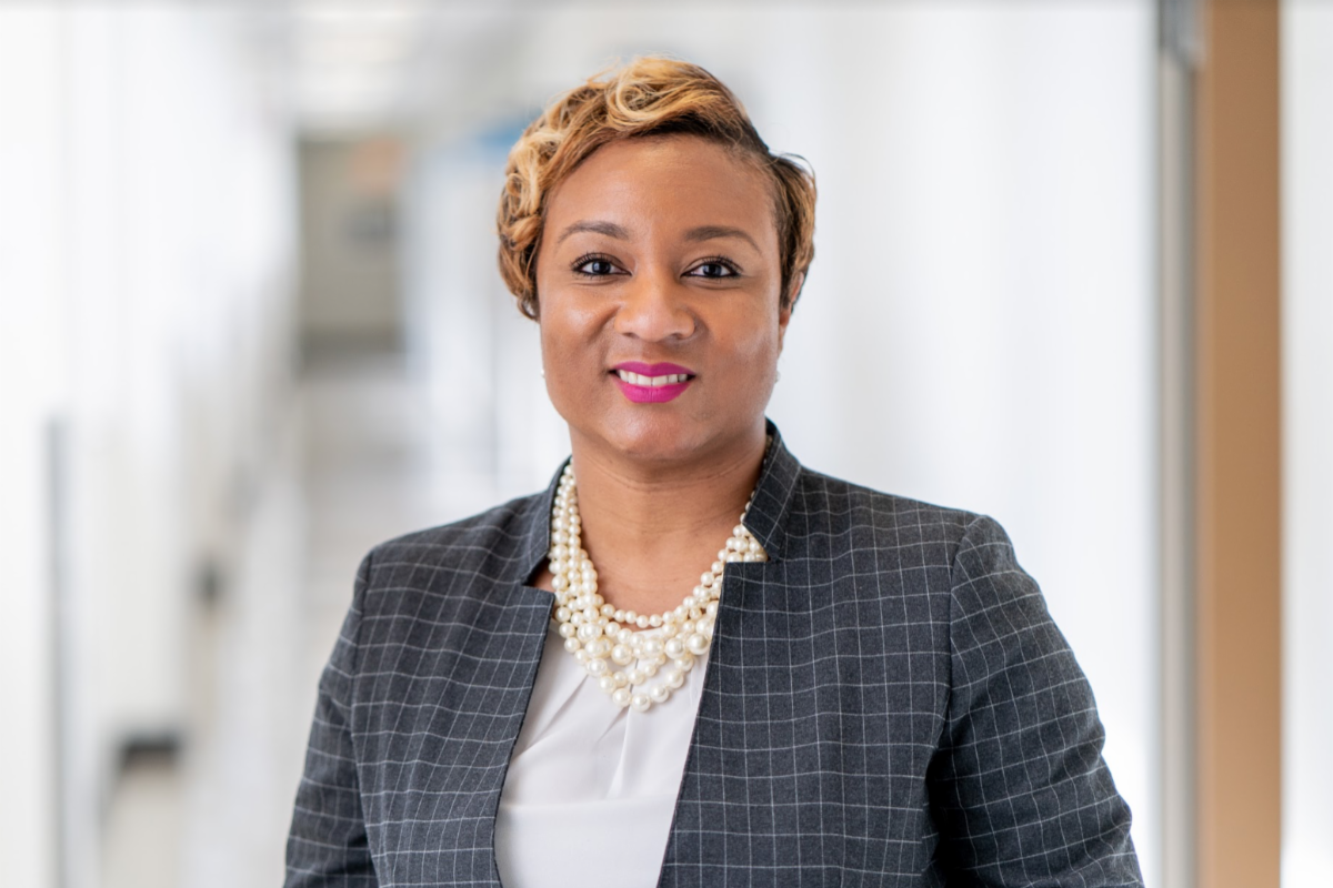 A post photo of a woman in a gray suit facing the camera.
