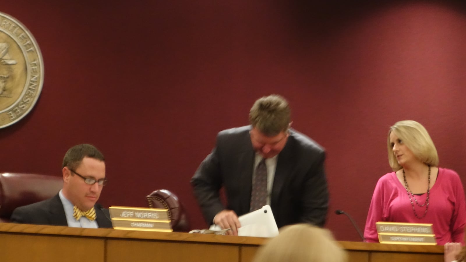 Bartlett Superintendent David Stephens (center) packs up after a busy working board meeting.