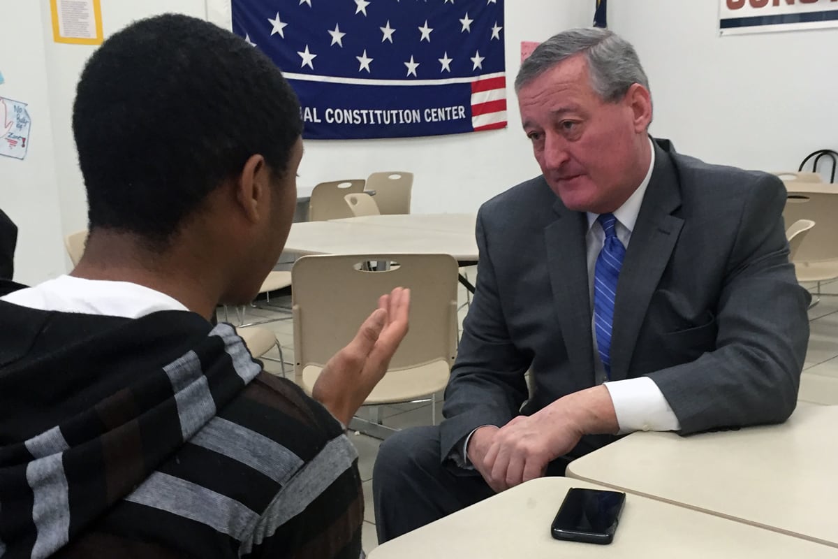 Jim Kenney and a student having a conversation in a classroom.