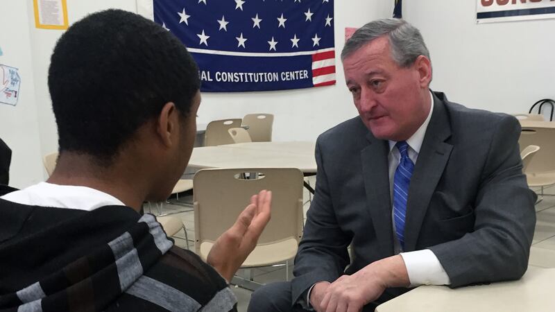 Jim Kenney and a student having a conversation in a classroom.
