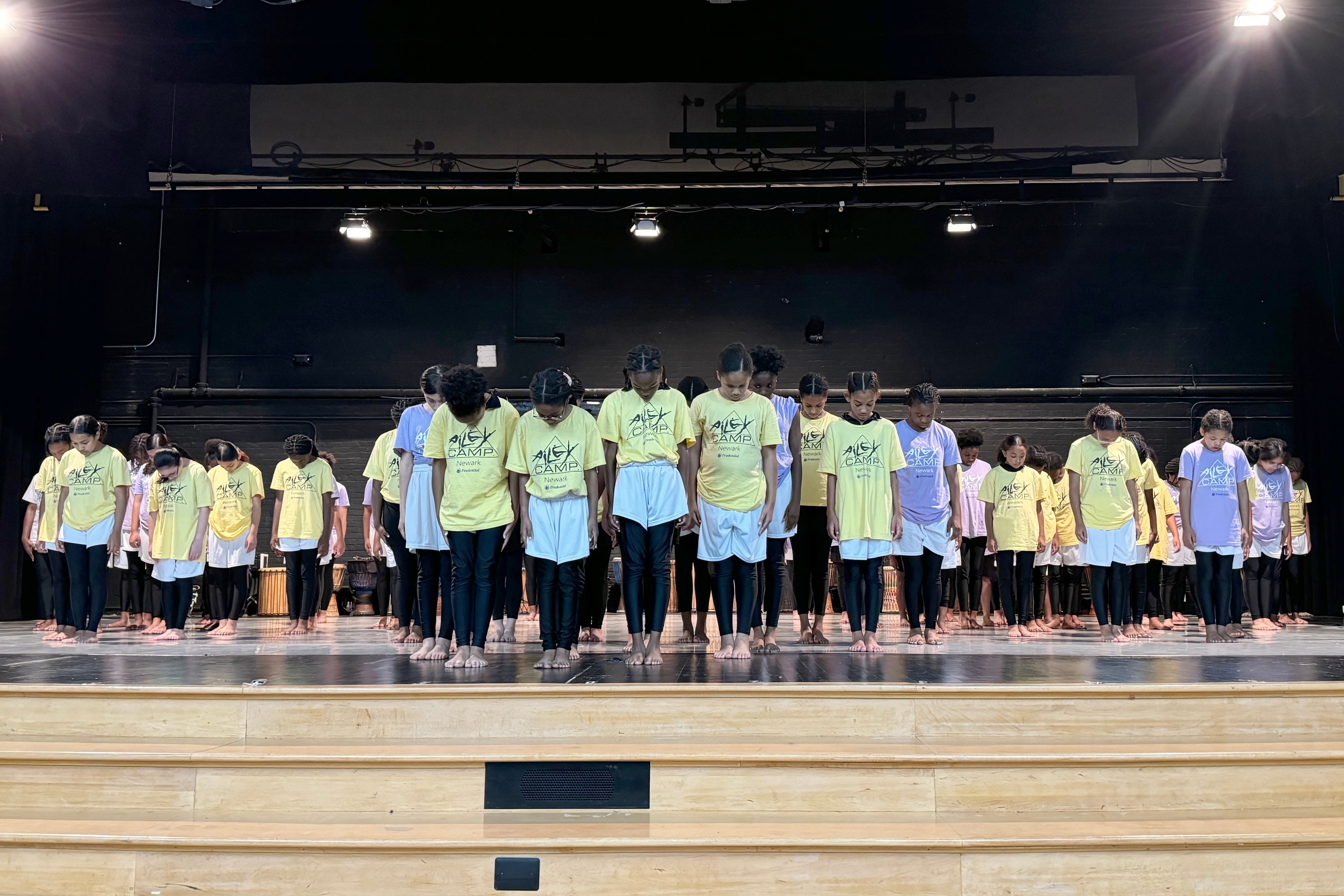 A group of students perform on stage.