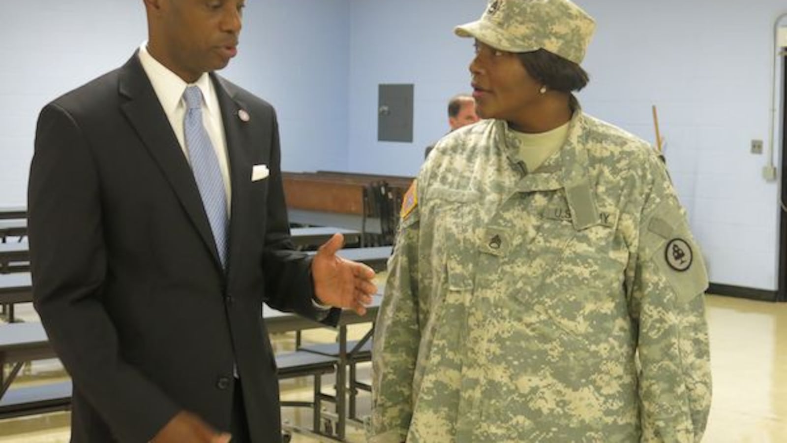 Shelby County Schools Superintendent Dorsey Hopson II talks academic goals with Riverview K-8 principal Rosalind Martin on the first day back to school Monday. Martin said her school’s theme this year is “Bootcamp to Improve Literacy.” Martin and her staff will wear their military gear each Monday during the school year.