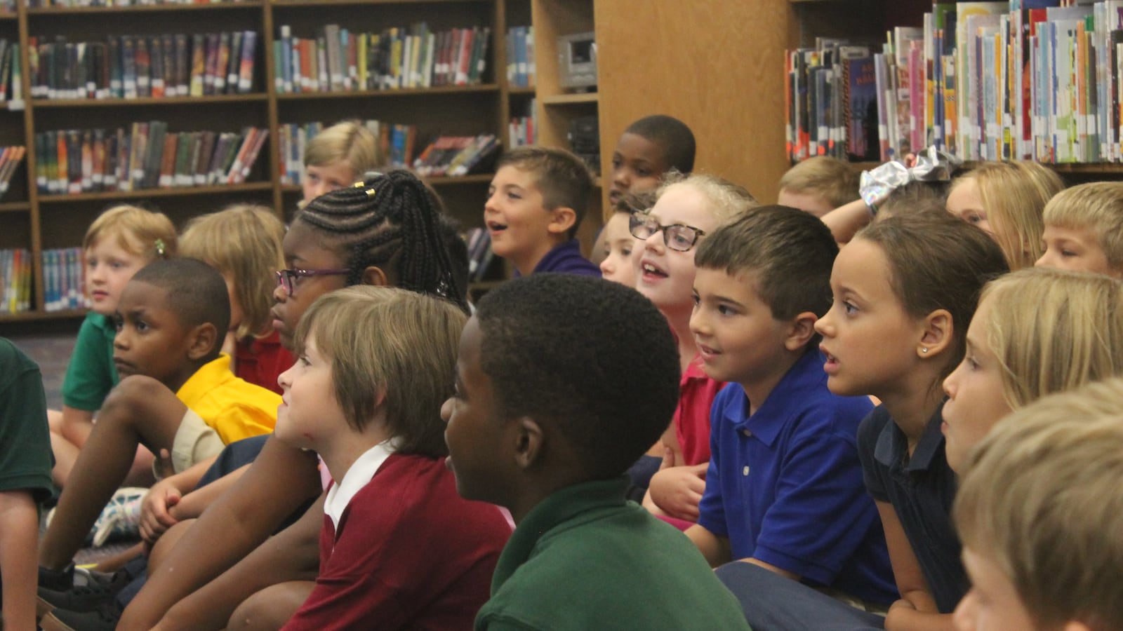 Second grade students listened attentively as Ferebee read a children’s book in the school library.