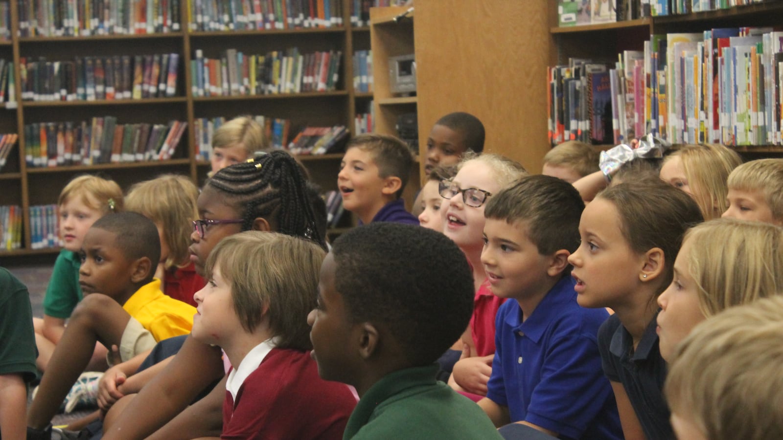 Second grade students listened attentively as Ferebee read a children’s book in the school library.