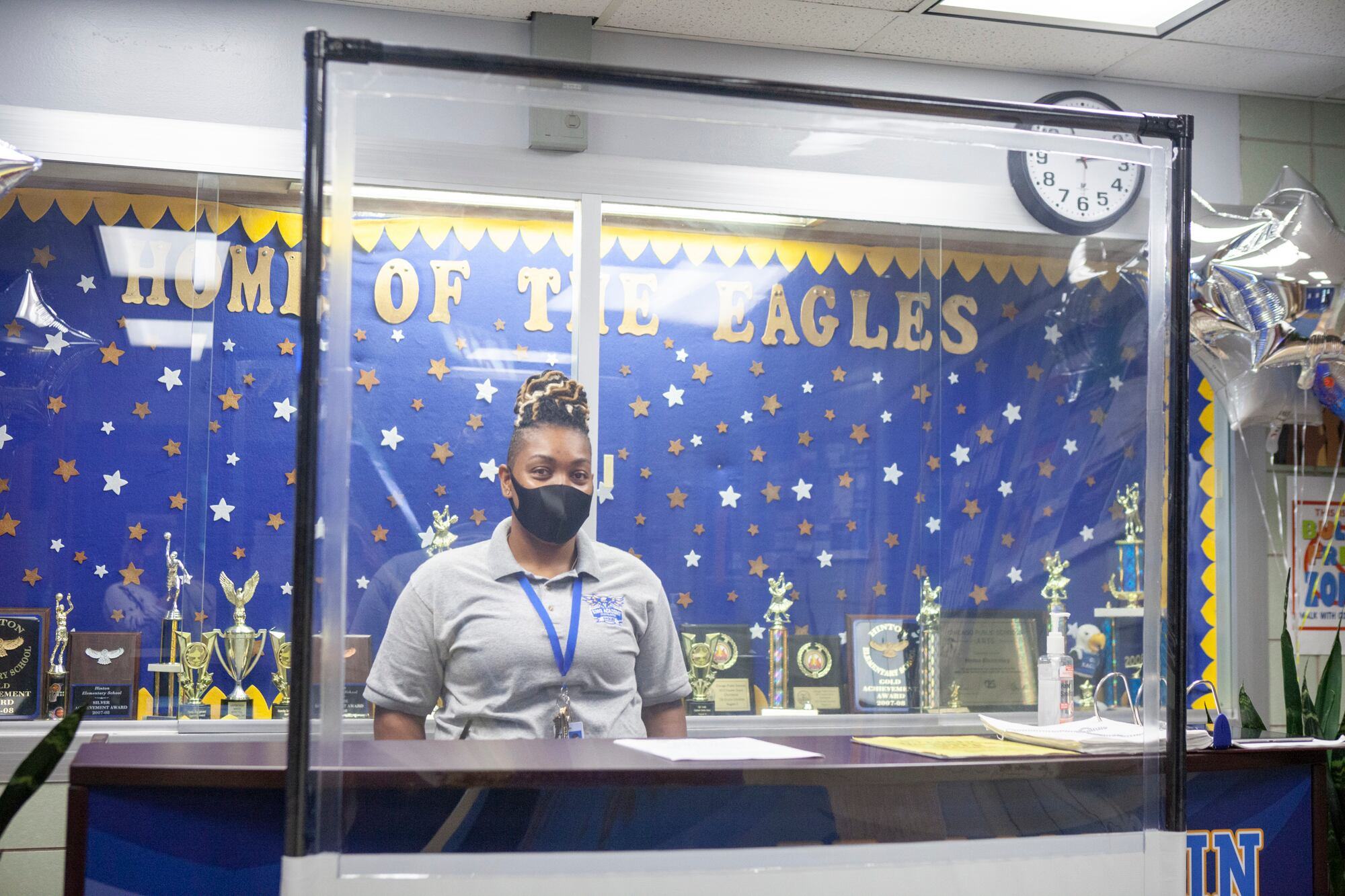 A health screening station with balloons that read welcome back.