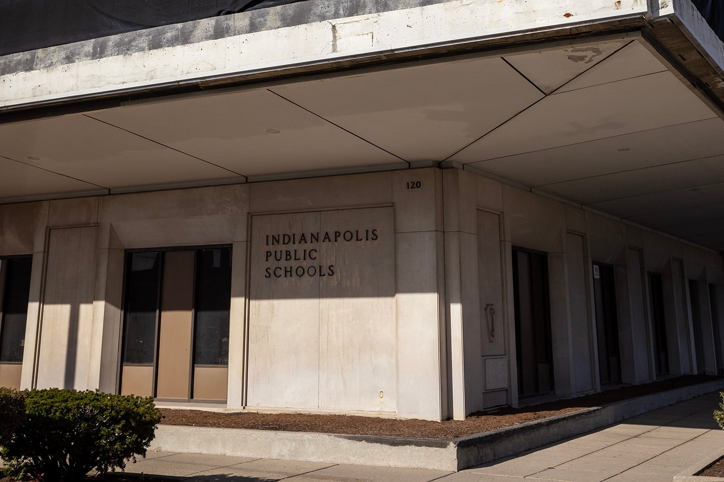 The corner of a building with a sign on the side.