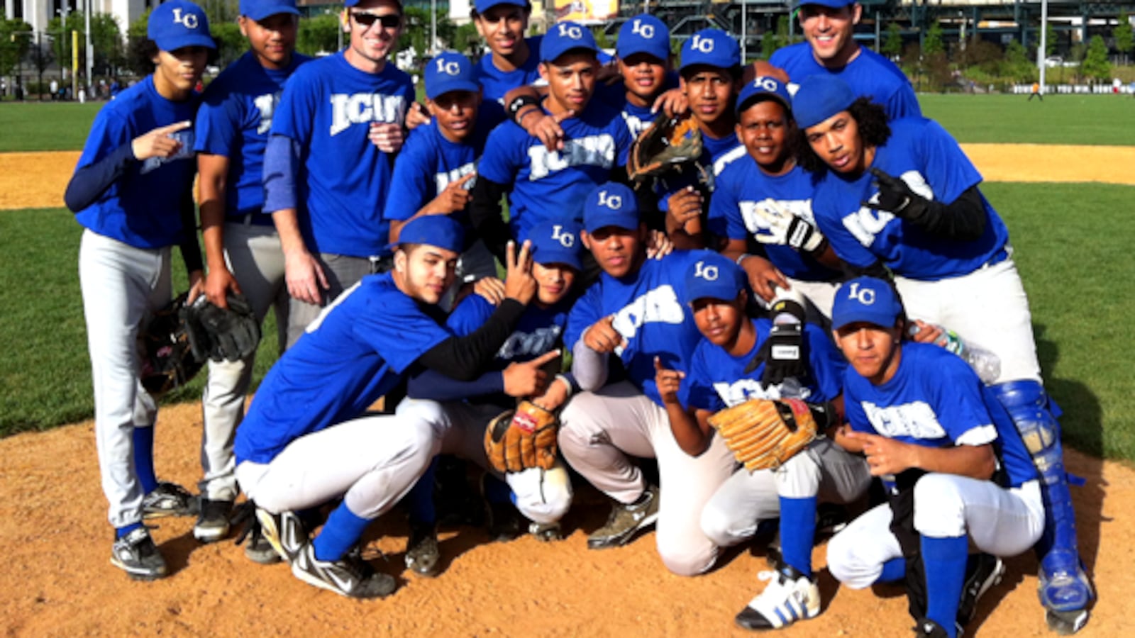 David Garcia-Rosen, pictured top left, poses with his International Community High School Baseball Team that he coaches through the Small Schools Athletic League.
