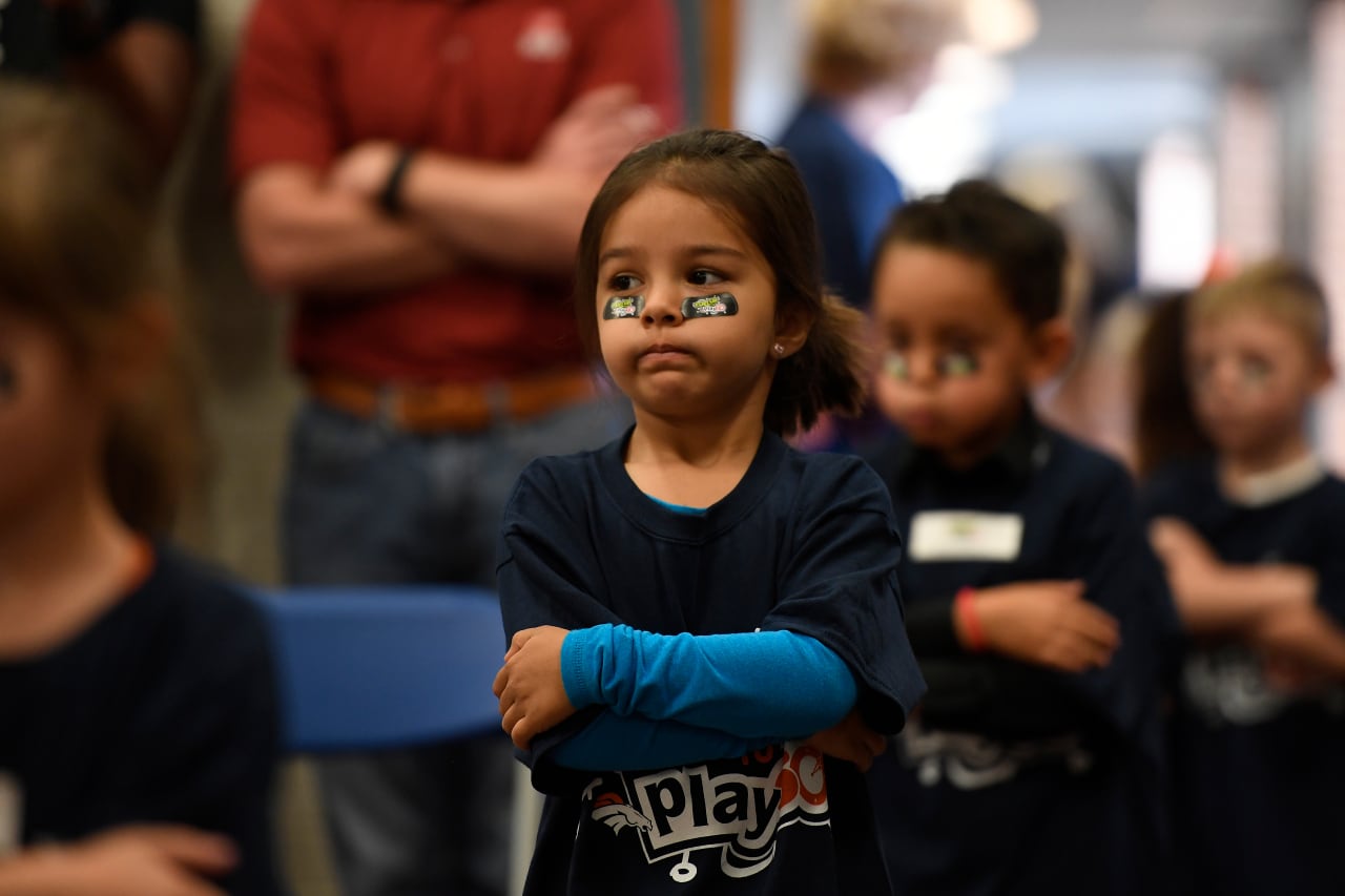 Allendale Elementary kindergarten students lined up ready for an assembly in their gym with arms crossed.
