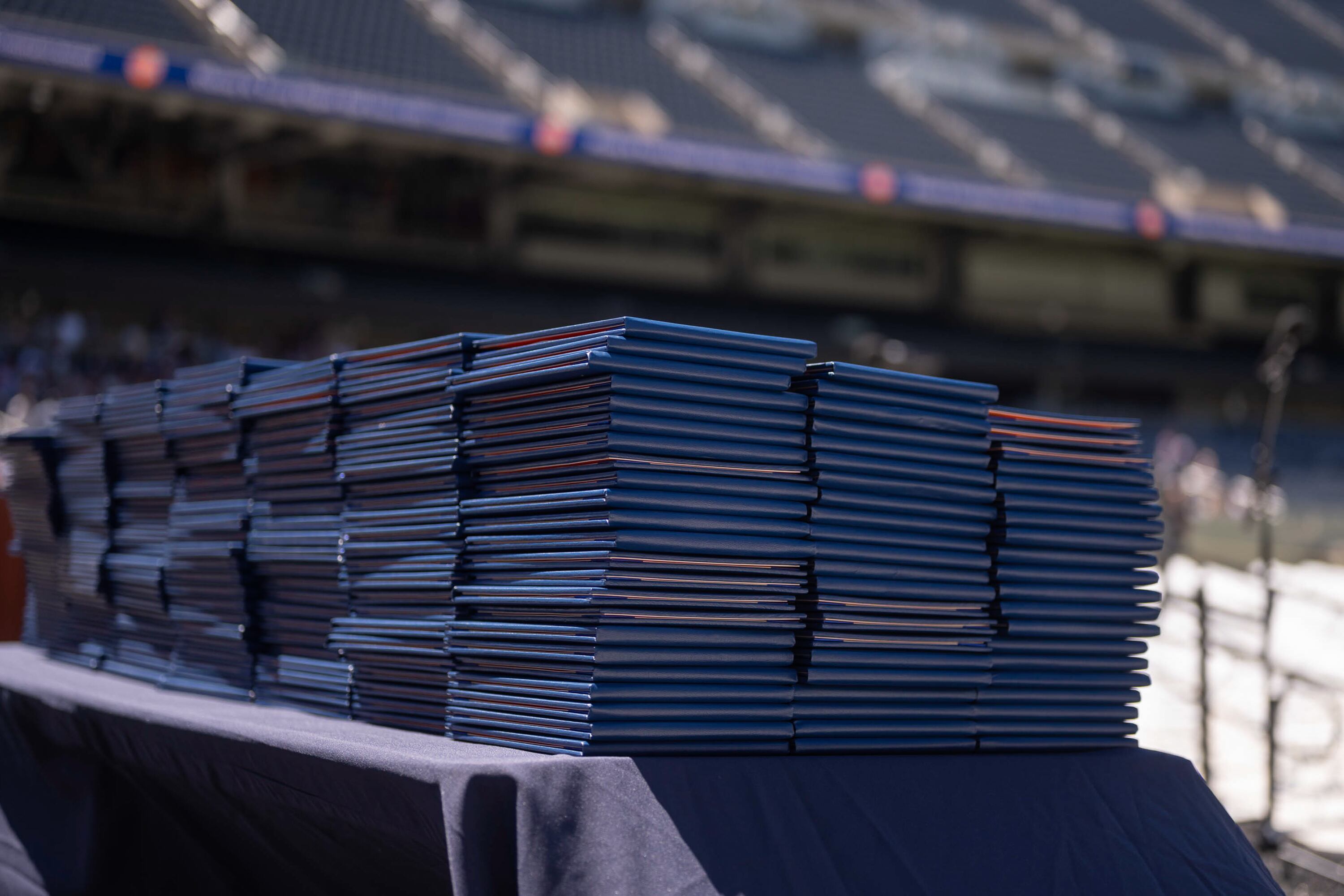Diplomas sit stacked on a table, waiting to be given to Whitney M. Young Magnet High School graduates.