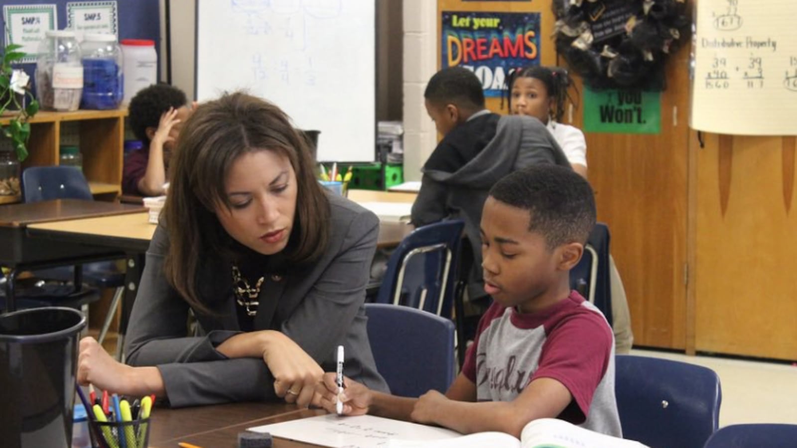 Penny Schwinn looks at classwork with a student in Memphis in February, soon after becoming Tennessee's education commissioner.