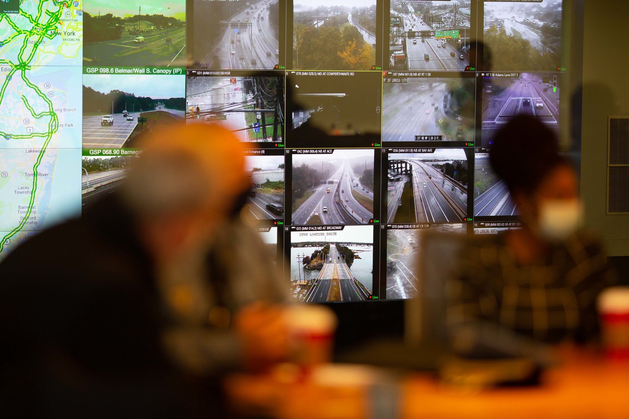 Multiple monitors show images of traffic on roads and highways at the NJ Statewide Traffic Management Center.