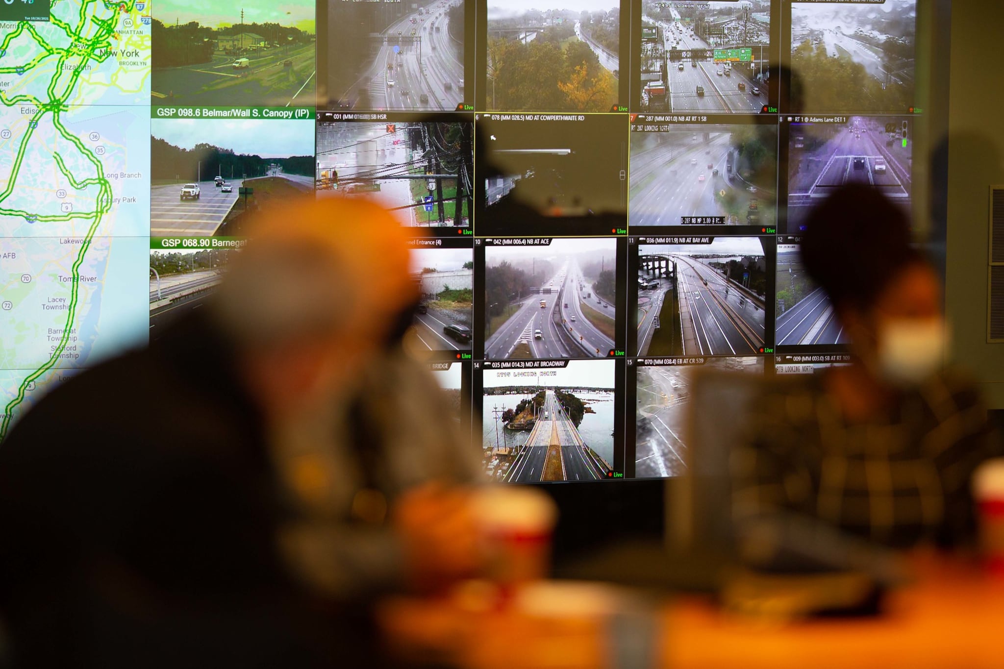 Multiple monitors show images of traffic on roads and highways at the NJ Statewide Traffic Management Center.