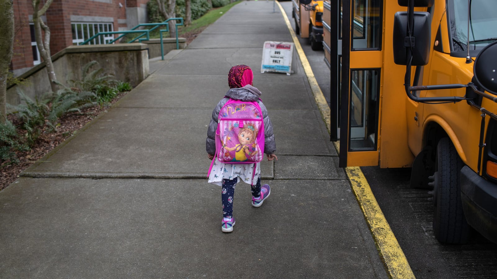 A student leaves a school in Seattle, where coronavirus fears have led to school closures. Across the country, the virus is prompting schools to rethink their attendance policies.
