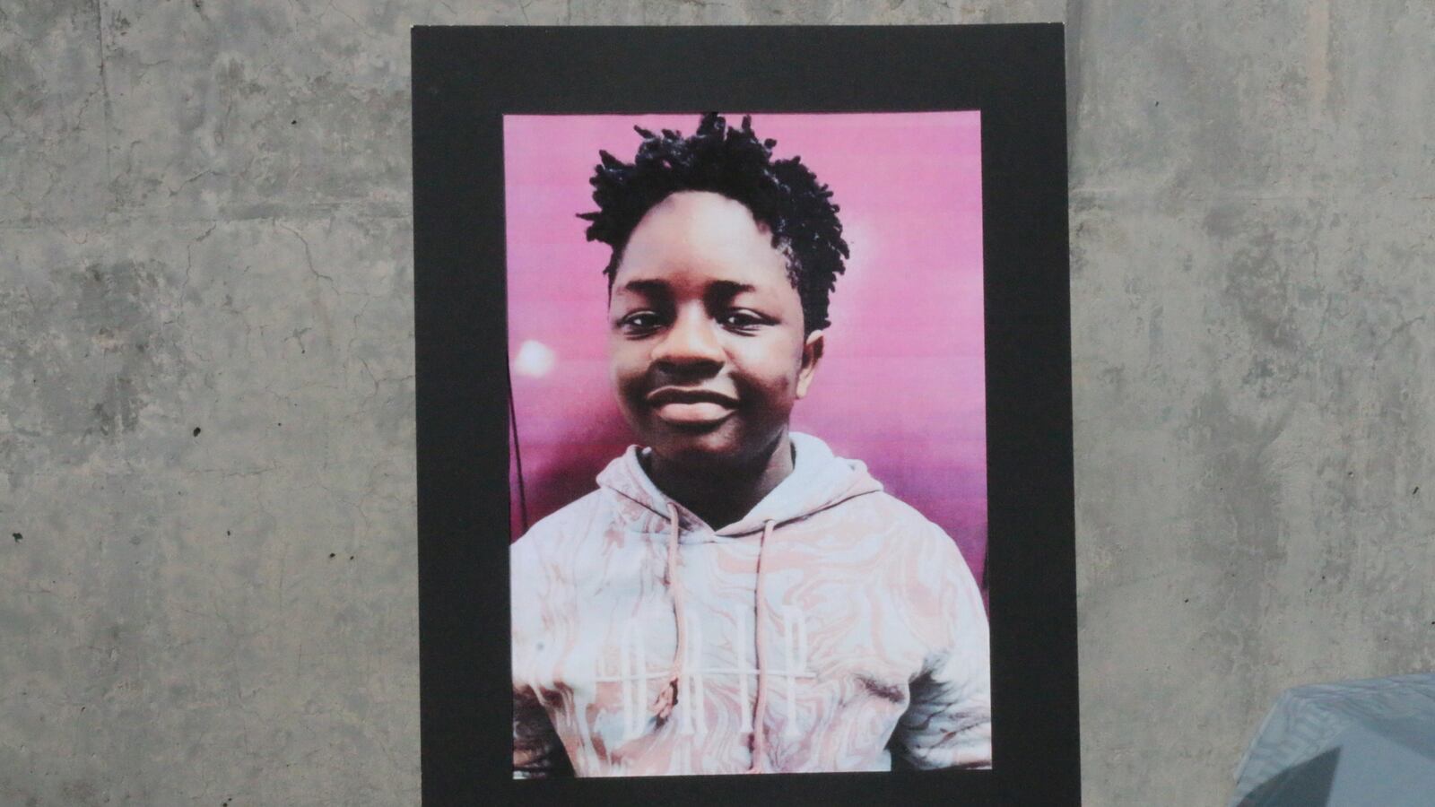 A poster shows an enlarged photo of 12-year-old Kade Lewin