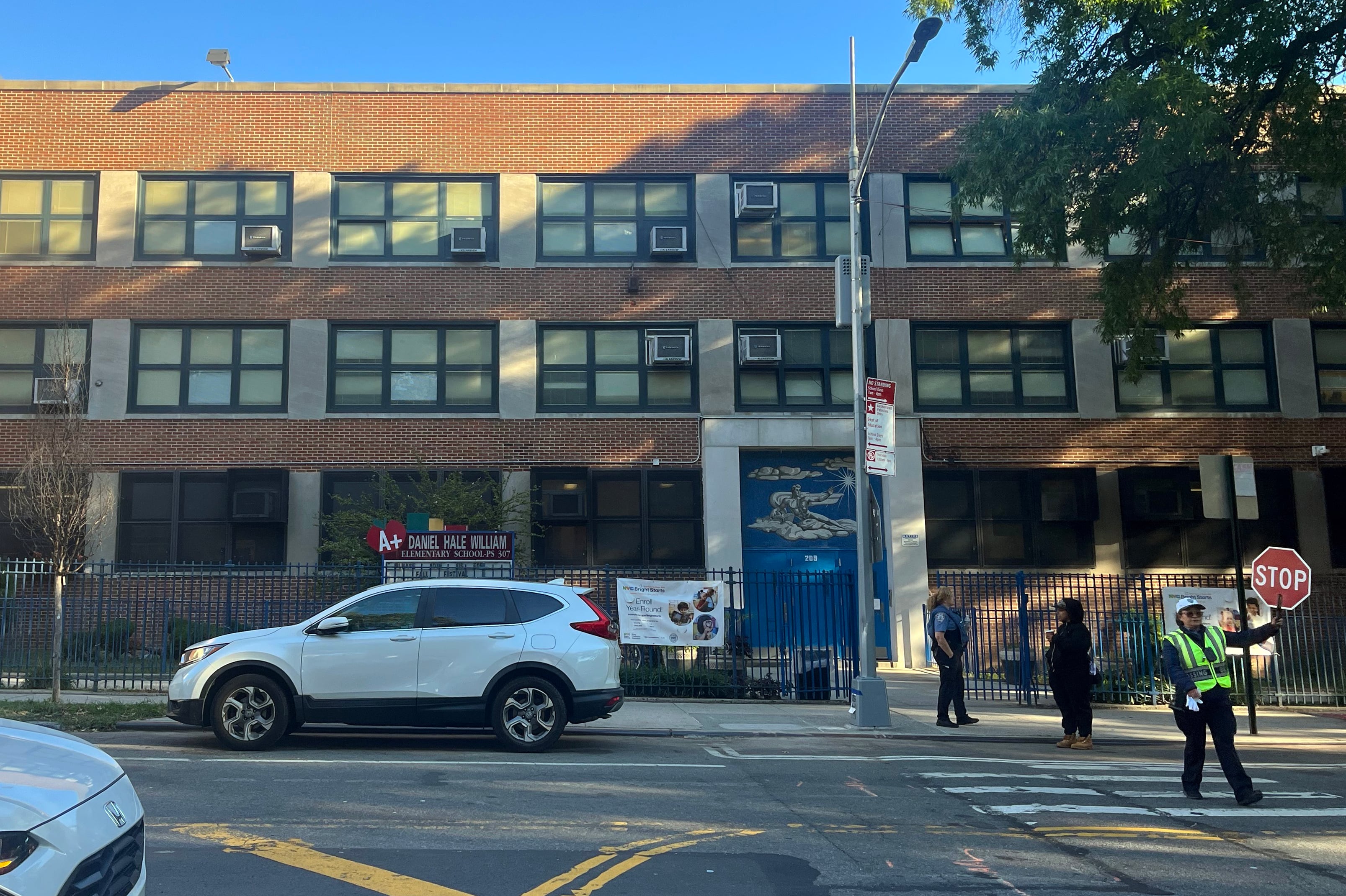 The outside of a school building on a sunny fall day.